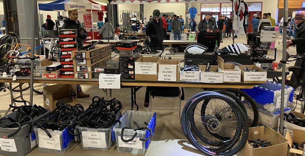 A table of bike goods for sale at the Brazen Dropouts bike swap on Jan 21, 2023