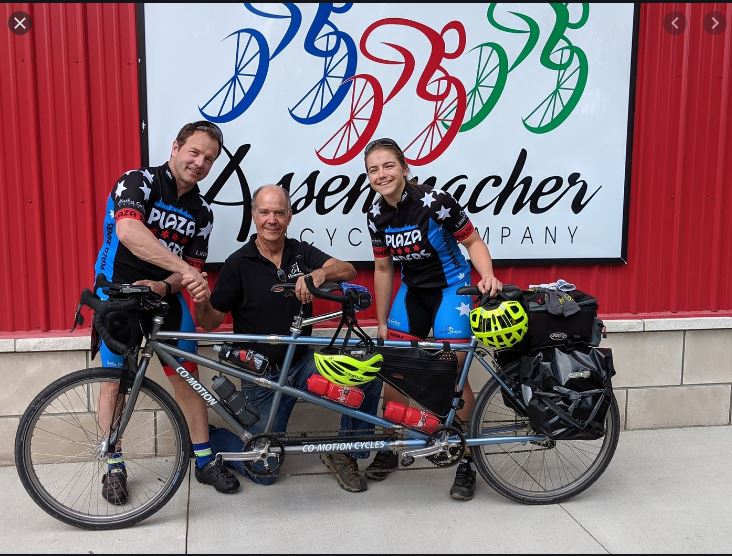 Troy and Carlin Henikoff with the bike technician that fixed their tandem bike