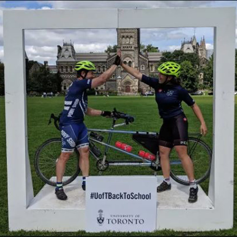 Troy and Carlin Henikoff in cycling gear and their tandem bike after arriving at college in Tornato