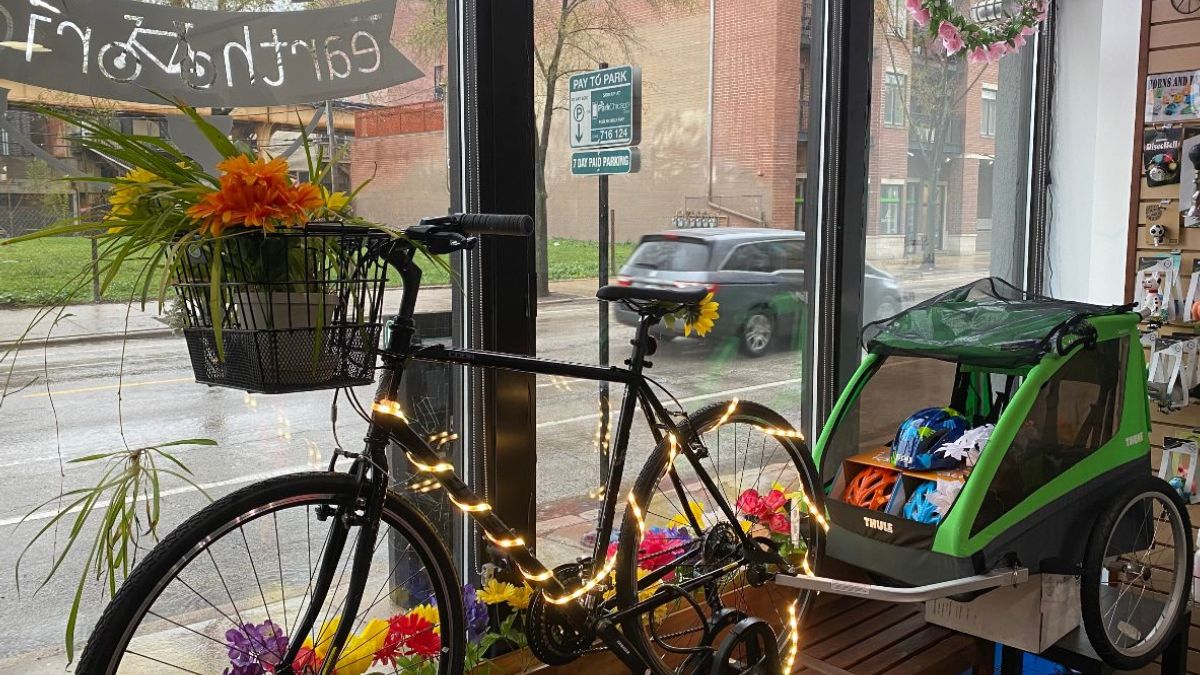 Bike spring flowers in Earth RIder bike shop window celebrating cycling in bloom