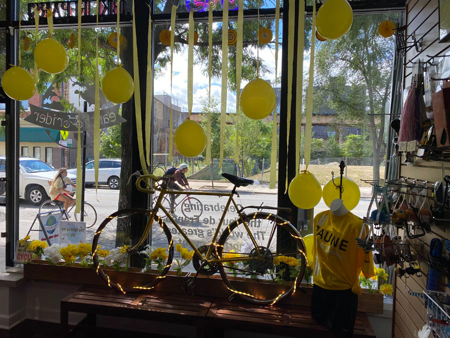 Earth Rider Bike shop window with yellow streamers and balloons celebrating the Tour de France bike race