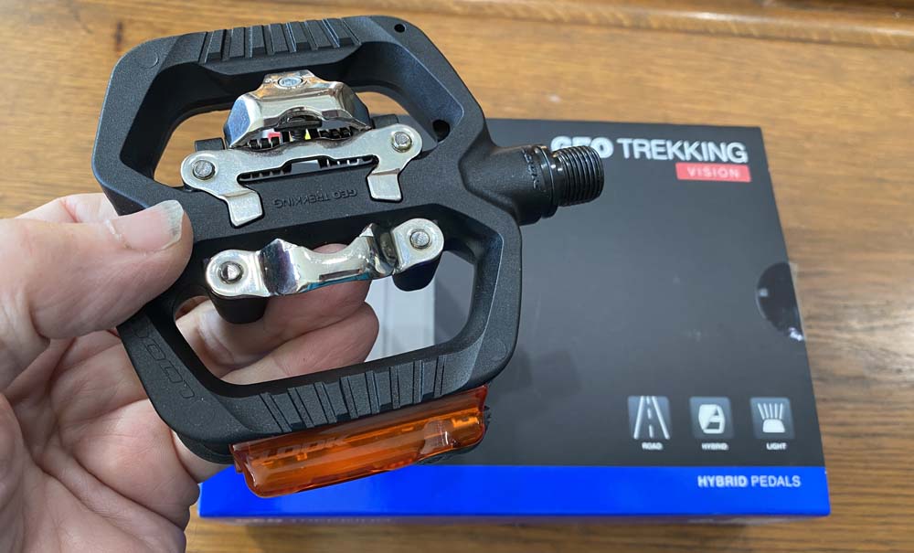 Look Geo Trekking Vision pedals that accomodate two hole cleats and have rechargeable lights on the sides 
