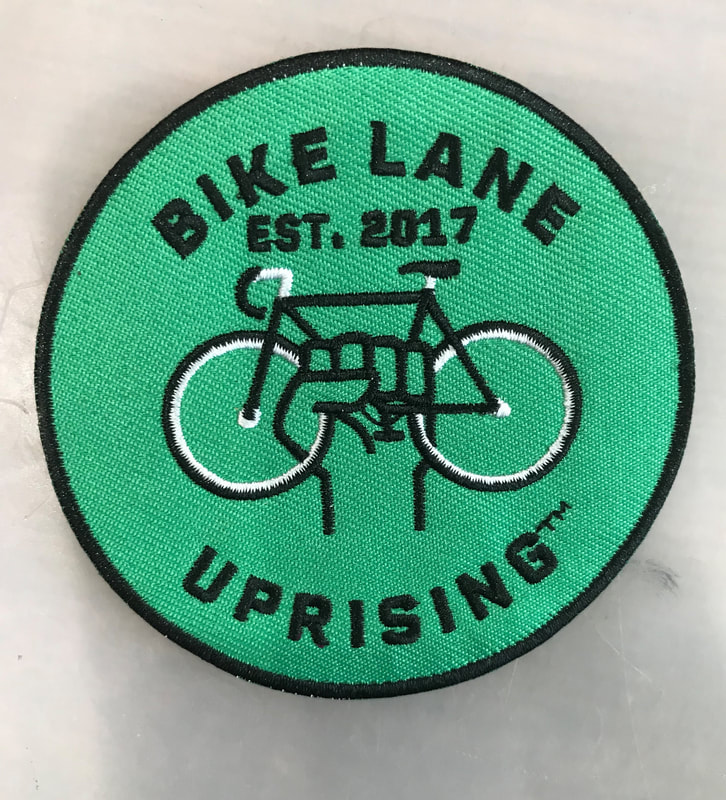 Bike Lane Uprising logo on a patch