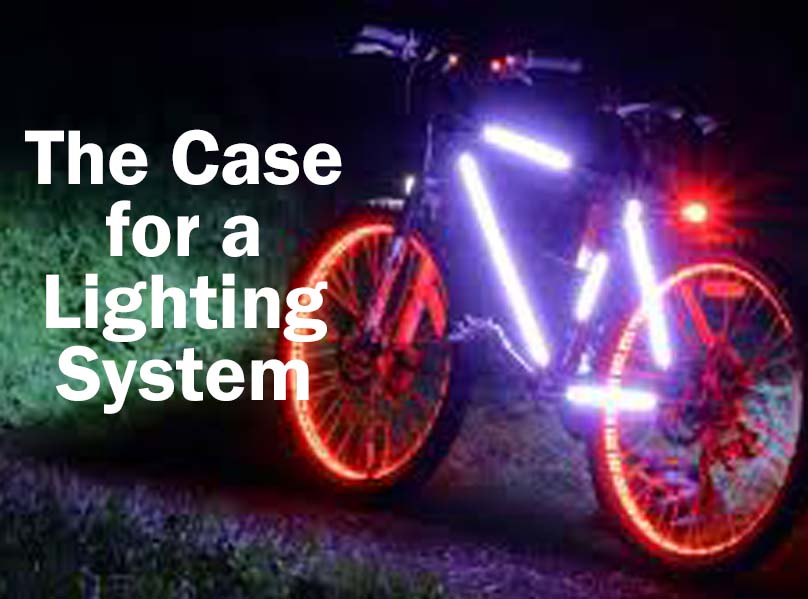 Bicycle at night with lights on wheels and frame