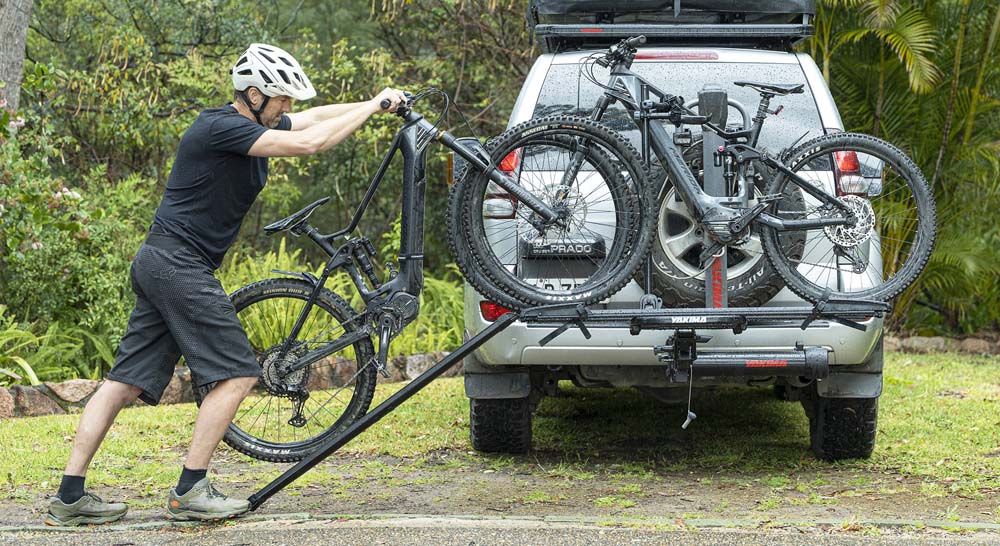 Rolling an ebike onto a hitch car rack for transportation