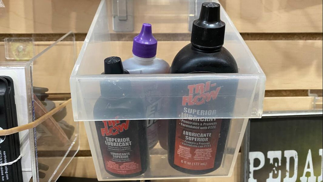 Bottles of Tri Low lubricant, 2oz and 6 oz