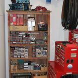 Bicycle tool chest and bookcase of bike tubes and parts in the Earth Rider bike shop