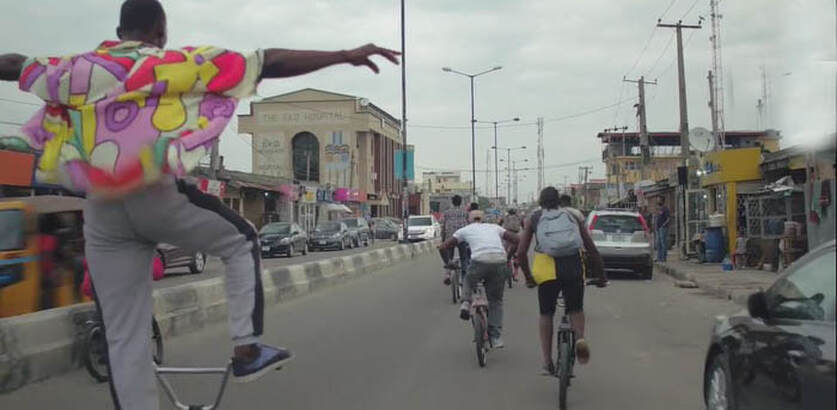 BMX bike riders doing tricks on the streets of Nigeria