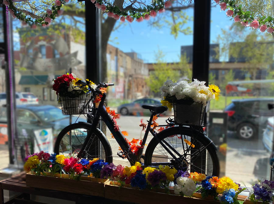 Bike covered with flowers in a business window
