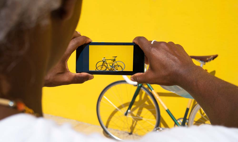 Person taking a photo of a bike with a smart phone camera
