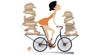 Cyclist on a bike carrying books on front and back racks