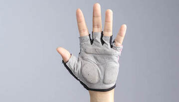 Hand raised wearing a padded short fingered cycling glove.